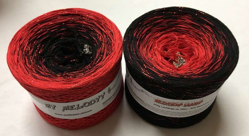 2 cakes of the Wolltraum My Melodyy gradient yarn colourway Bloody Mary.  It goes from red to black with red glitter throughout.