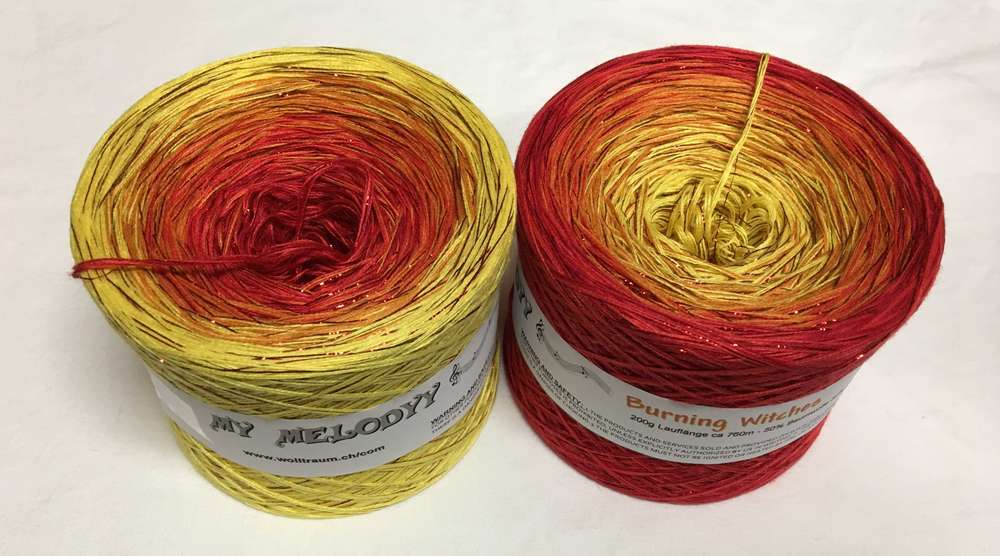 2 cakes of the Wolltraum My Melodyy gradient yarn colourway Burning Witches.  It goes from yellow to red with red glitter throughout.