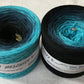 A gradient yarn cake that goes from light blue to black.