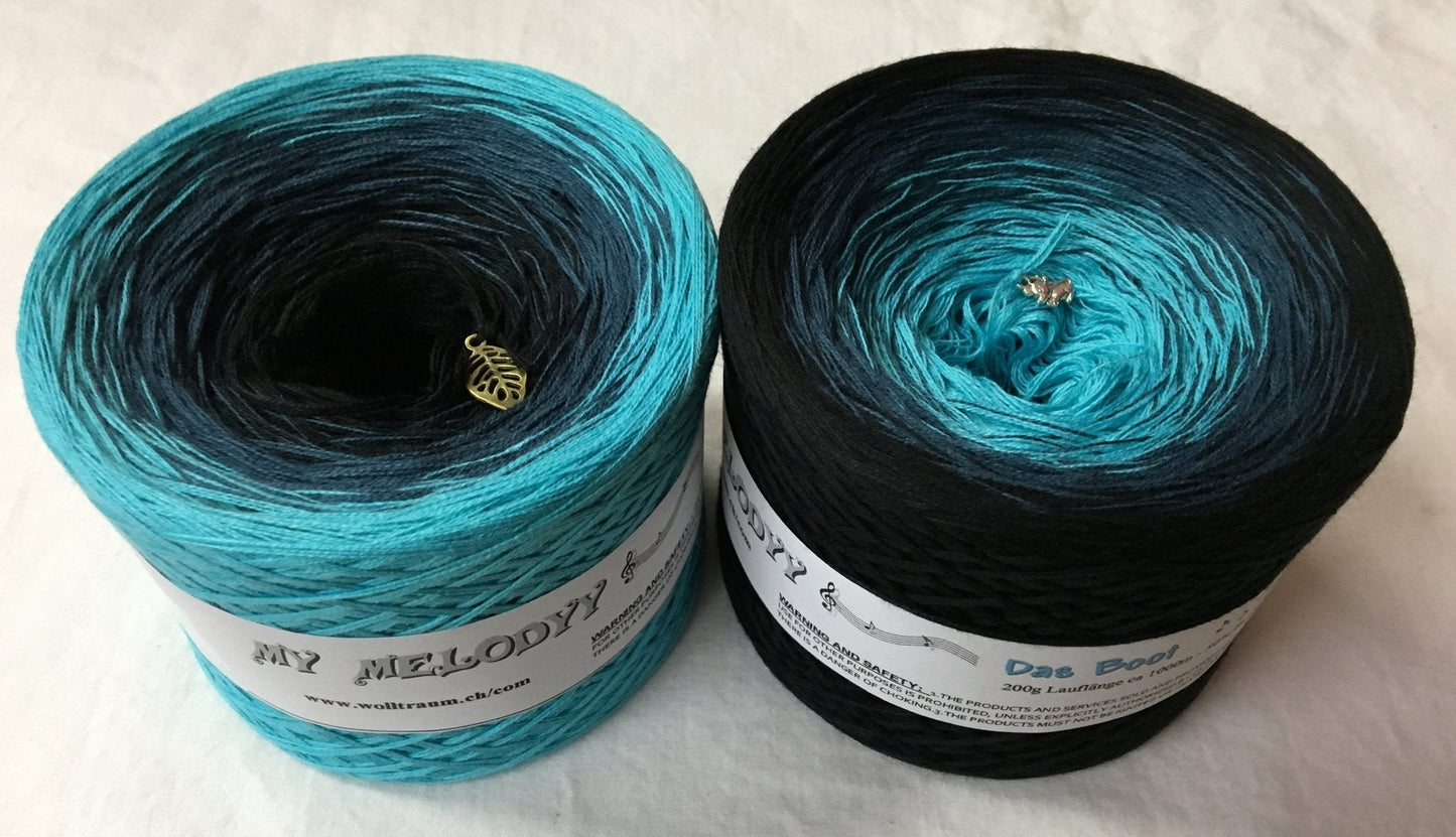 A gradient yarn cake that goes from light blue to black.