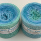 2 cakes of the Wolltraum My Melodyy gradient yarn colourway Blue Lagoon.  It contains mixed light blues and light green.