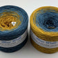 2 cakes of the Wolltraum My Melodyy gradient yarn colourway Blue Wall.  It goes from a dusky blue to curry yellow.