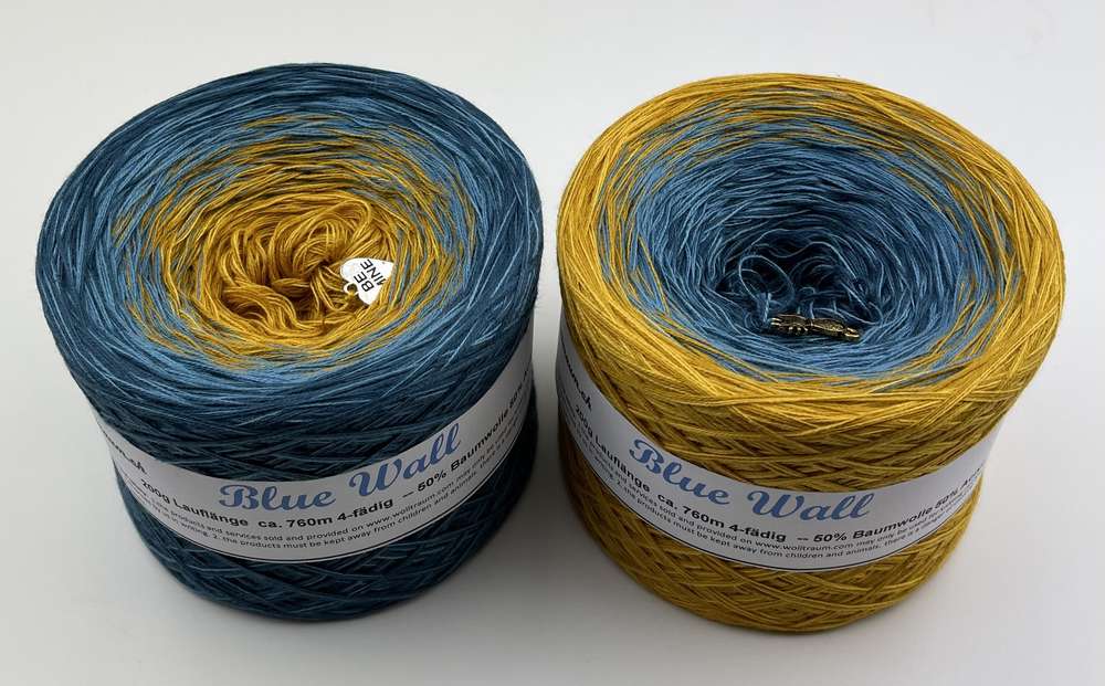 2 cakes of the Wolltraum My Melodyy gradient yarn colourway Blue Wall.  It goes from a dusky blue to curry yellow.