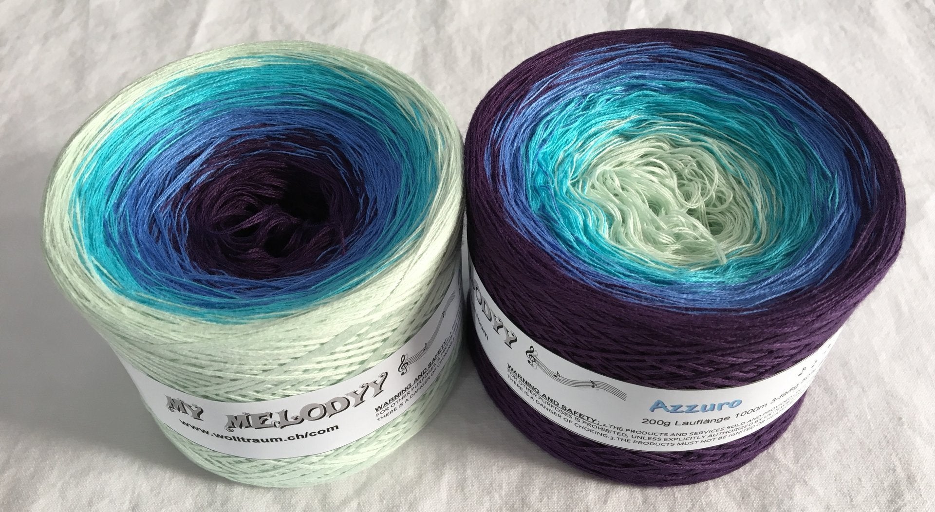 The Wolltraum My Melodyy gradient yarn colourway Azzuro.  This cake has an ombre effect that goes from light green to dark blue.