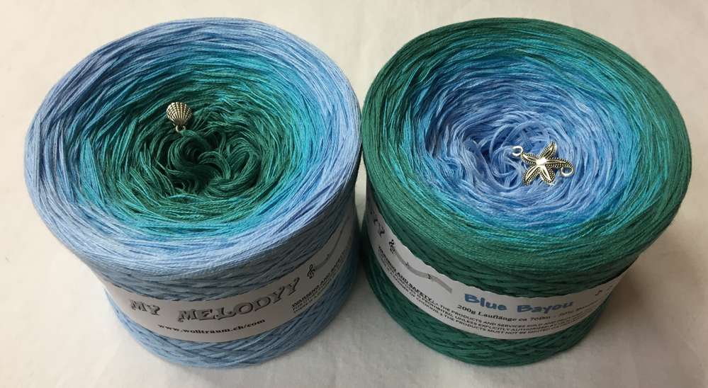 2 cakes of the Wolltraum My Melodyy gradient yarn colourway Blue Bayou.  It goes from light blue to ocean green.