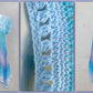 The photos of a tunic top made with Wolltraum yarn in the colour Blue Bayou.