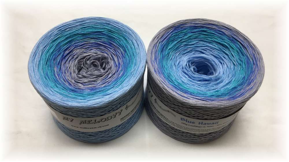 2 cakes of the Wolltraum My Melodyy gradient yarn colourway Blue Hawaii.  It is mixed with different shades of blue and grey/purple.
