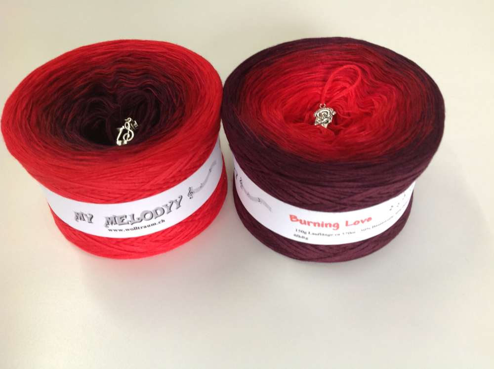 2 cakes of the Wolltraum My Melodyy gradient yarn colourway Burning Love.  It goes from bright red to a deep red-purple.