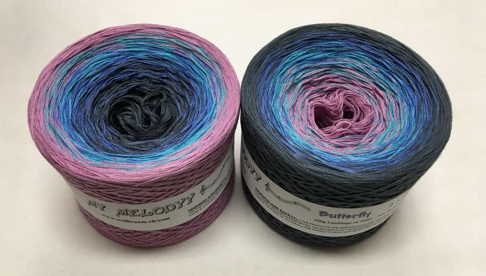 2 cakes of the Wolltraum My Melodyy gradient yarn colourway Butterfly.  It goes from purple to blue to dark grey.